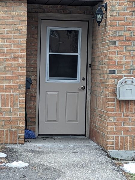 gray entry door with two glass panels insert